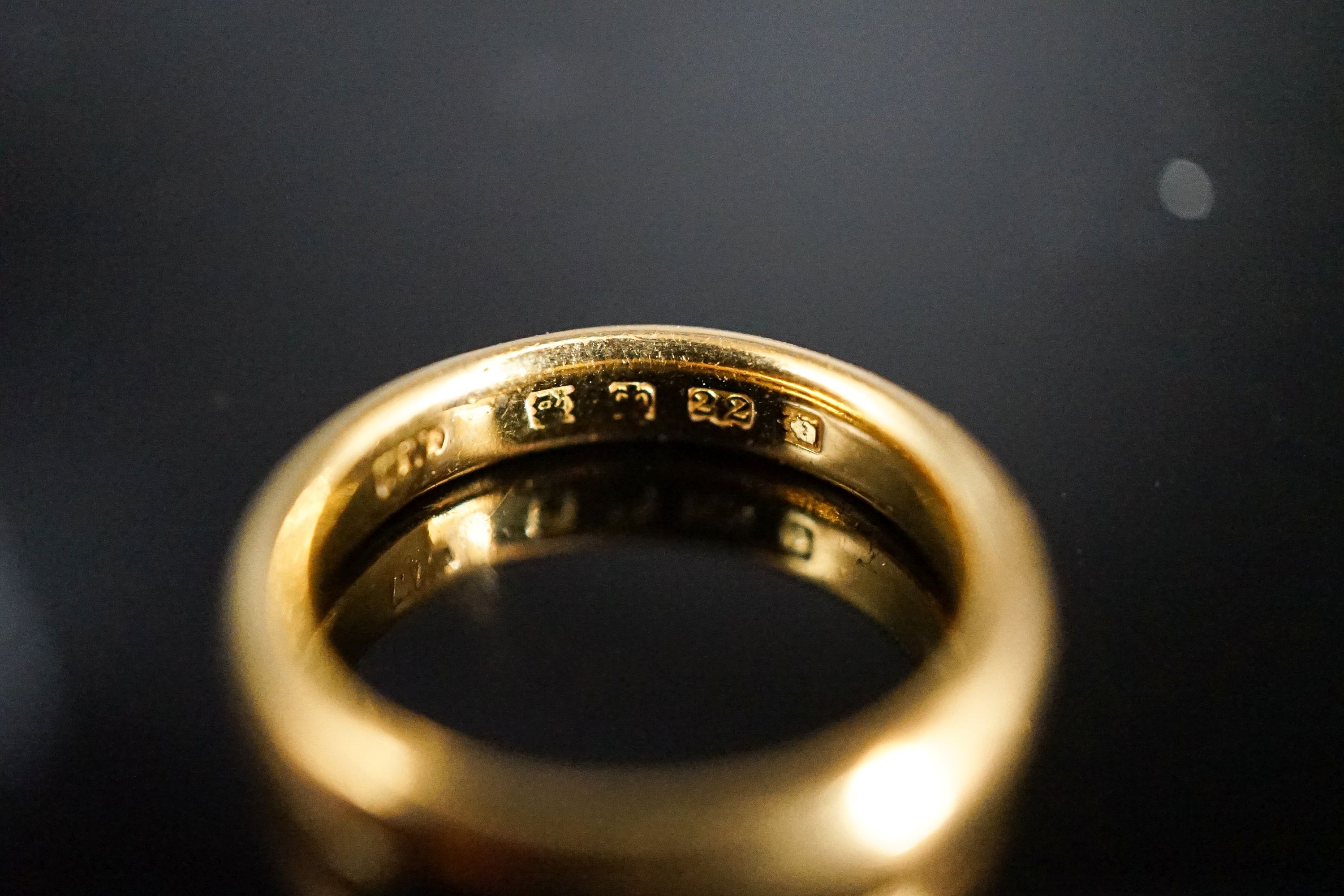 A 22ct. yellow gold wedding band, size L, 6.4 grams.